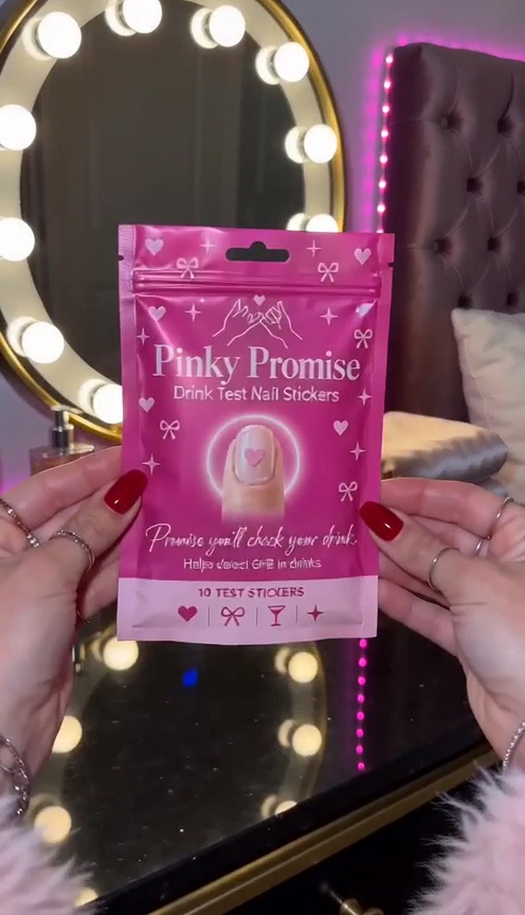 Pinky Promise pouch held up at a vanity mirror