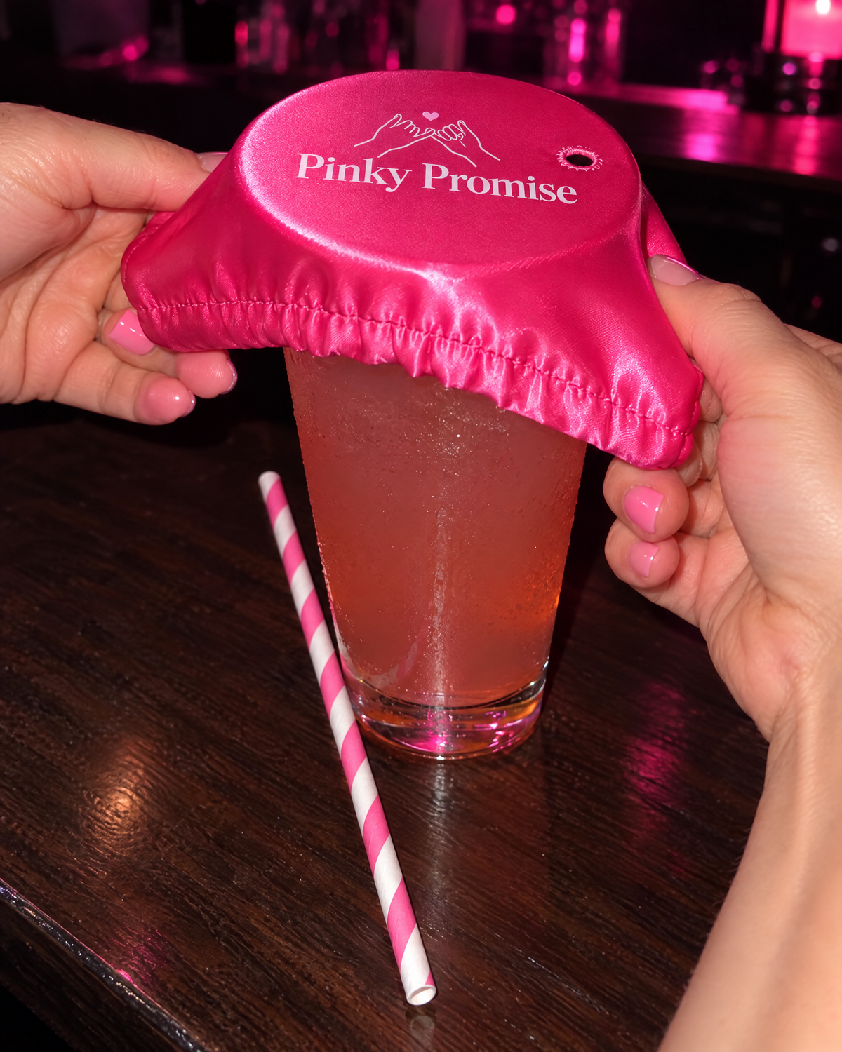 Stretching the drink cover over a glass